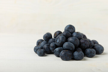 Blueberries on white textured background. Ripe and fresh blueberries. Vitamins. Healthy food. Juicy berry.Copy space.Place for text