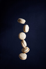 Macarons cookie levitation on dark background