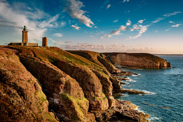 Cliff landscape with lighthouse in a sunset light. Cap Frehel, Brittany - North France, English...