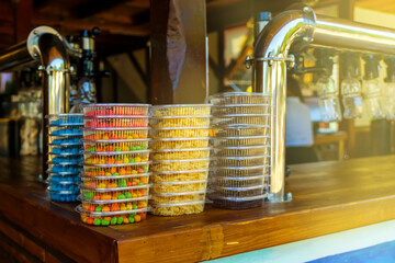 Snacks for beer colorful nuts and dried fish are on the counter next to the faucets