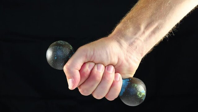 Old dumbbells 1 kg in hand. dumbbells for sports training