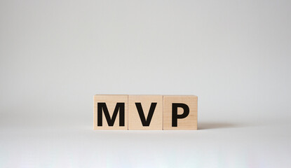 MVP symbol. Wooden cubes with words MVP. Beautiful white background. Business and MVP concept. Copy space.