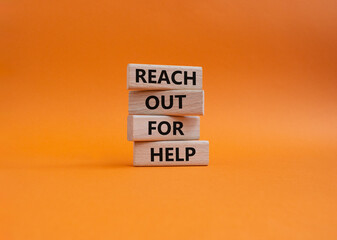 Reach out for help symbol. Wooden blocks with words Reach out for help. Beautiful orange background. Business and Reach out for help concept. Copy space.