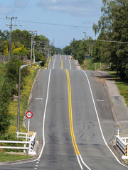 long road ahead undulating with double yellow lines