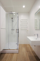 Modern bathroom interior with shower cabin and washbasin