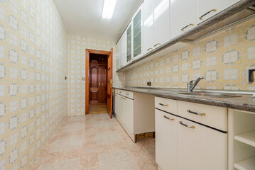 Kitchen with white gloss wood cabinets, gray granite countertops and vintage tiles