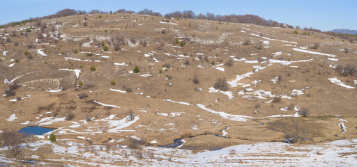 mountain ridge on blue cloudy sky background