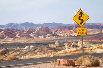 Scene in the American Southwest, showing S curves ahead four miles of winding roads and interstate...