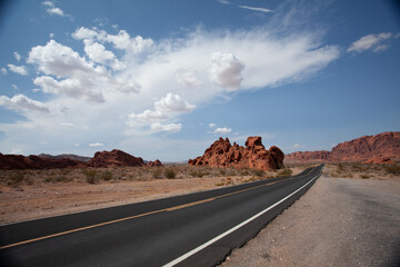 Dark asphalt on a desert interstate highway running through the American Southwest during a heat...