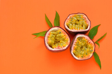 sliced ​​passion fruit on orange background close up