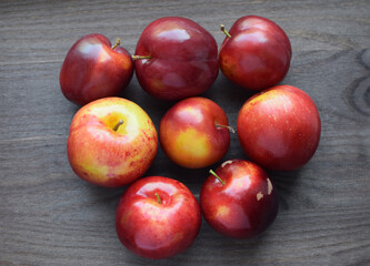 Juicy red ripe plums on a dark wooden background. Vegan concept. Healthy organic food.