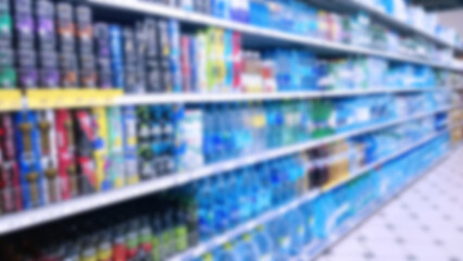 Abstract blur image of supermarket background. Defocused shelves with products. Grocery store....