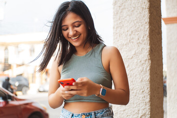 Young latin american young woman using a mobile looking a meme.