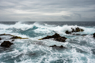 Stormy weather with big waves on rocky coast