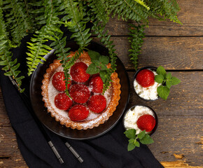 Shortbread tartlets with strawberries and whipped cream. View from above