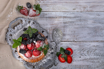 Tartlets with strawberries, with black blackberries. view from above