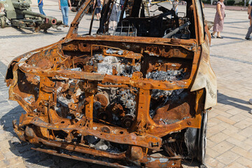 View of the burnt civilian car. Rusty car doors. Stop war. Rusty metal. War in Ukraine