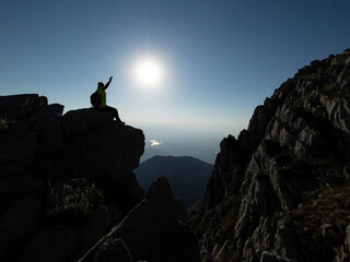 the joy of victory and success of the mountaineer reaching the peaks of the high mountains