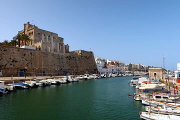 Ciutadella, Menorca (Minorca), Spain. Ciutatella marina (Puerto de Ciutadella) with boats and yachts and Town Hall building view. Sunny day in the marina of Ciutedella