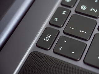 Close-up of the Esc key on the laptop keyboard. Selective focus.