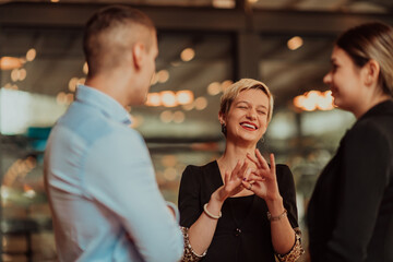 Photo of a business team of young people discussing business ideas in a modern urban environment. Selective focus 