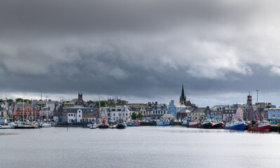 Naklejka premium 18 August 2022. Stornoway, Isle of Lewis, Highlands and Islands, Scotland. This is a scene of Stornoway Harbour on an August morning as rain clouds started to break up.