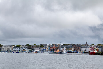Naklejka premium 18 August 2022. Stornoway, Isle of Lewis, Highlands and Islands, Scotland. This is a scene of Stornoway Harbour on an August morning as rain clouds started to break up.
