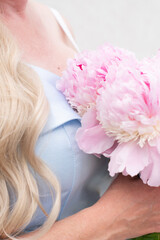 bride in a blue wedding dress with a bouquet of pink peonies, pastel paradise