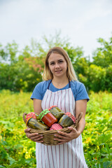 A woman preserves vegetables in jars. Selective focus.