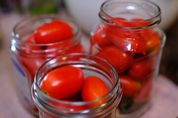 Homemade pickled tomatoes in glass jars Fermented tomatoes in transparent glass. Homemade canned tomatoes.