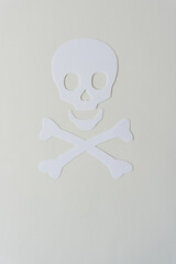 simple white paper skull and crossbones on blank paper