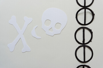 deconstructed paper skull and black cancel symbols
