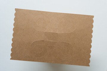 looped square outline on brown paper