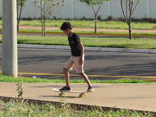Boy skateboarding on the sidewalk. Skateboard maneuver. Skater boy.