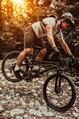 Obraz premium Cyclist Riding the Bike on the Trail in the Forest. Man cycling on enduro trail track. Sport fitness motivation and inspiration. Extreme Sport Concept. Selective focus