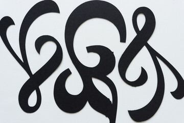 black paper flourishes or ornamentation shapes on a white background
