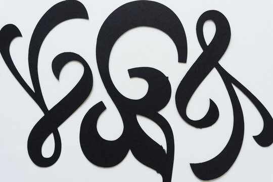 black paper flourishes or ornamentation shapes on a white background