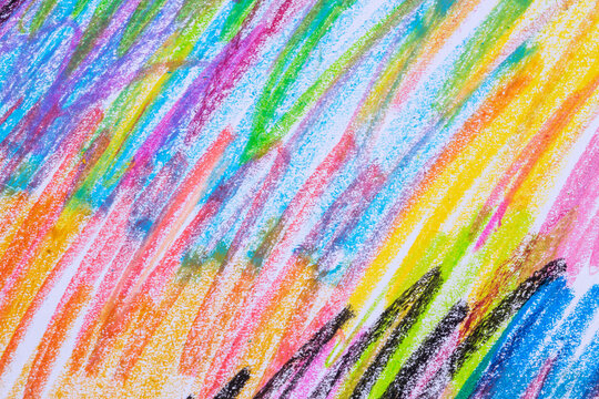 Colorful pastel crayons with painting background