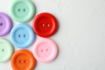 Many sewing buttons on white background, top view