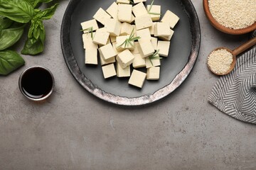 Delicious tofu with rosemary served on grey table, flat lay