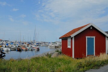 swedish red house with a coast with yachts - obrazy, fototapety, plakaty