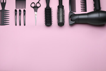 Flat lay composition with modern hair dryer on pink background, space for text