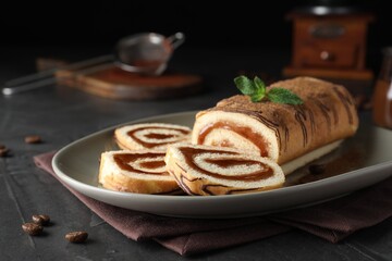 Tasty cake roll with jam and mint on grey table