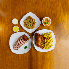 Pollo al cilindro, Chancho o cerdo al cilindro, arroz chaufa, papas fritas y cremas