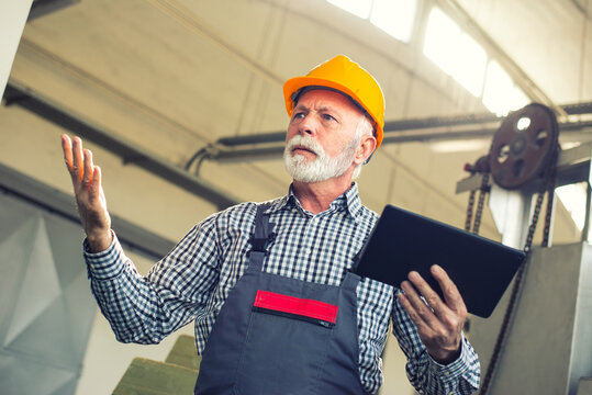 Senior Man Blue Collar Worker Working In The Factory