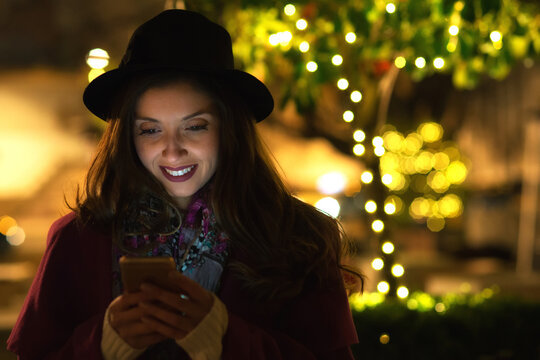 Young Woman Using Smart Phone On The City Street At Night