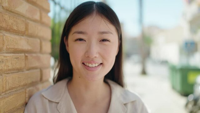 Chinese woman smiling confident standing at street