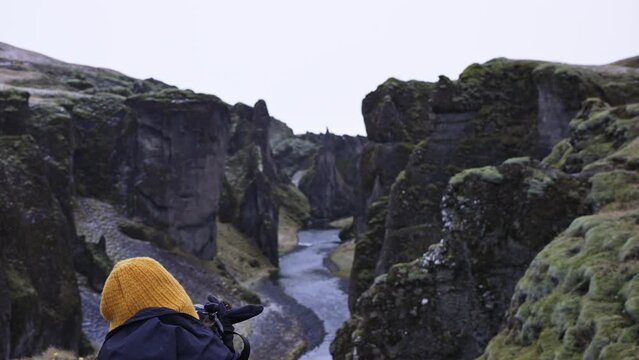 Tourist taking picture in Fjadrargljufur canyon in Iceland.