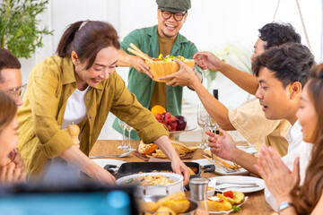 Group of Asian man and woman friends having dinner with drinking wine and talking together on...