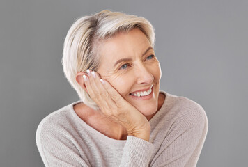 Thinking, idea and memory with a senior woman resting her head or chin on her hand in studio on a...